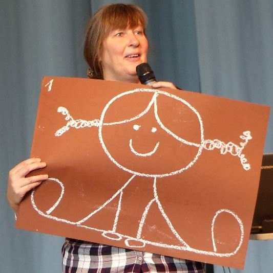 Petra Jäger von Flensburg with her PowerPoint-to-go-slides, on the picture she shows who she was 25 years ago